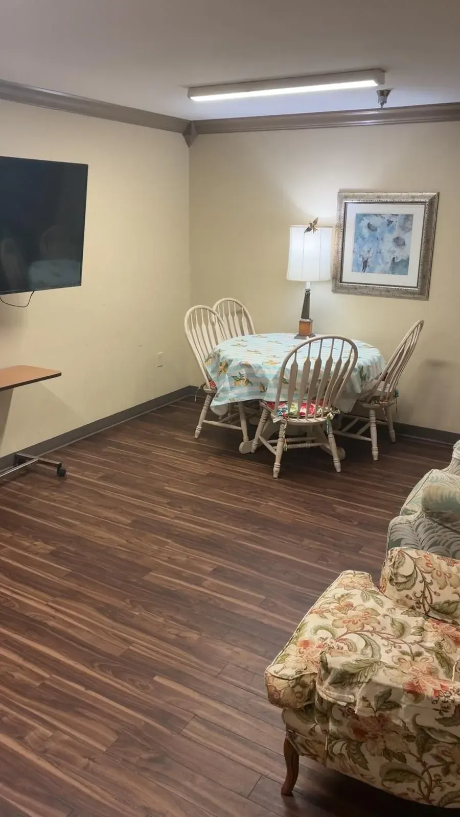A dining table and chairs in a common room at Vivo Healthcare Gandy